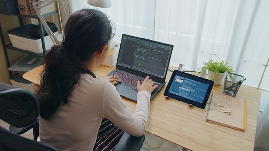 Woman learning Python on her laptop.